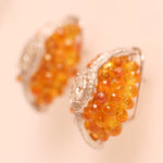 Load image into Gallery viewer, Oval Cluster Orange Sapphire Halo Huggie Earrings
